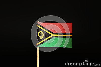 A official Flag of Vanuatu on wooden stick on black background. It is island state and belongs to Oceania Stock Photo