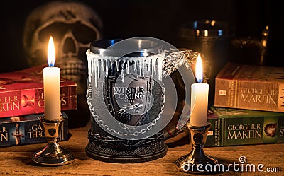 Official House Stark tankard from Game of Thrones series lit by candlelight Editorial Stock Photo