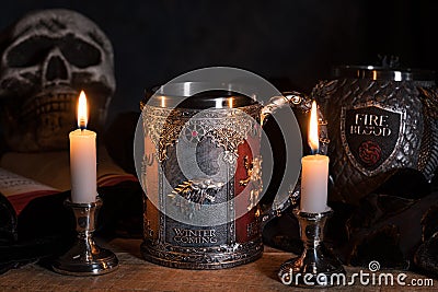 Official House Stark tankard from Game of Thrones series lit by candlelight Editorial Stock Photo