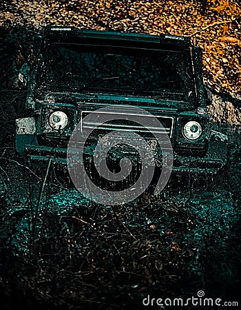 Offroad vehicle goes on mountain way. Off-road vehicle goes on the mountain. Mudding is off-roading through an area of Stock Photo