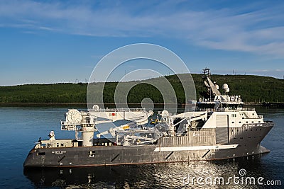 Offshore AHTS anchorhandling and construction vessel Olympic Zeus inside the fjord in Murmansk Editorial Stock Photo