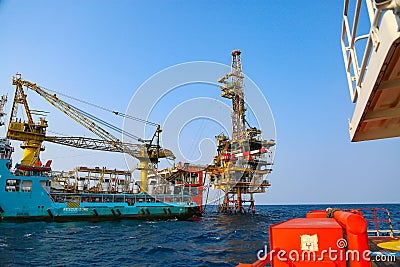 Offshore construction platform for production oil and gas. Oil and gas industry and hard work. Production platform and operation Stock Photo