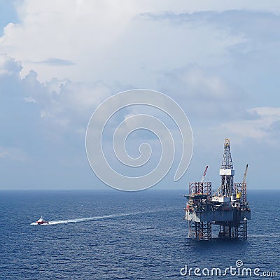 Offshore Drilling Platform (Jack up drilling rig) and crew boat Stock Photo