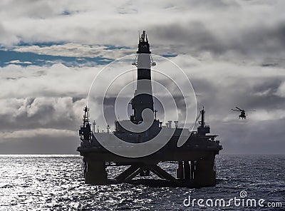 Offshore drilling rig in Gulf of Mexico, petroleum industry, with helicopter Stock Photo