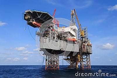 Offshore Jack Up Drilling Rig Over The Production Platform in Th Stock Photo