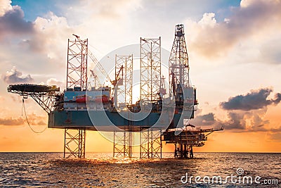 Offshore Jack Up Rig in The Middle of The Sea at Sunset Time Stock Photo