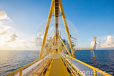 Offshore oil and gas central processing platform and flare platform while flaring. Stock Photo