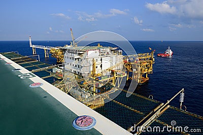 The offshore oil rig platform and supply boat Stock Photo