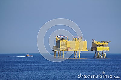 Offshore platform with supply boat Stock Photo