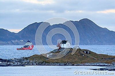 Offshore vessel AHTS passing the Haugsholmen Lighthouse Editorial Stock Photo