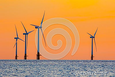 Offshore wind farm energy turbines at dawn. Surreal but natural Stock Photo