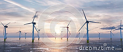 Offshore wind power and energy farm with many wind turbines on the ocean Stock Photo