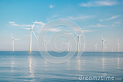 Offshore windmill park with stormy clouds and a blue sky, windmill park in the ocean Stock Photo