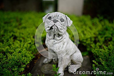 Dog figure bravely guarding a grave Stock Photo