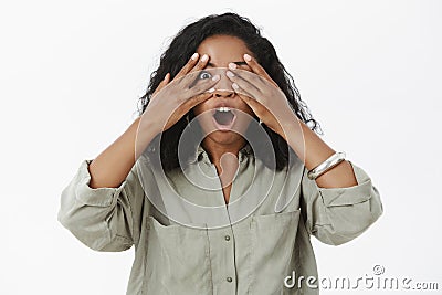 Oh gosh it awesome. Portrait of enthusiastic emotive and thrilled charming dark-skinned young female with curly hair Stock Photo