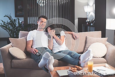 Cheerful married couple watching TV together Stock Photo