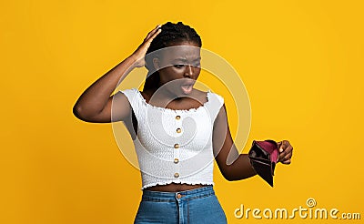 Oh No. Shocked Black Woman Looking At Empty Wallet In Her Hands Stock Photo