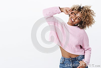 Oh yeah, girl enjoys winter holidays. Charismatic carefree and silly cute african american woman with blond afro haircut Stock Photo