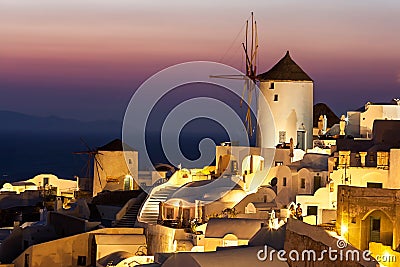 Oia at dusk, with beautiful windmill, Santorini island, Greece Editorial Stock Photo