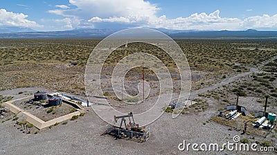 Oil Battery Gathering & Distribution System. Gas oil distribution station with cisterns on a yellow field with pumps pumping oil Stock Photo