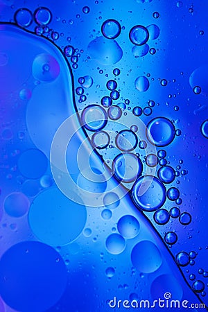 Oil bubbles in water . Blue and black colors tog hater. Stock Photo