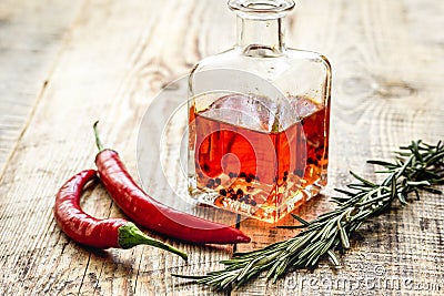 oil in carafe with spices and chili on wooden background mock-up Stock Photo