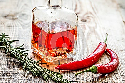 oil in carafe with spices and chili on wooden background mock-up Stock Photo