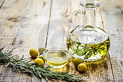 Oil in carafe with spices and olive on wooden background mock-up Stock Photo