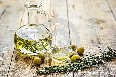 oil in carafe with spices and olive on wooden background mock-up Stock Photo