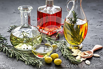 Oil in carafe with spices, olives and chili on stone background Stock Photo