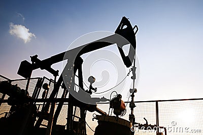 Oil derrick at sunset Stock Photo