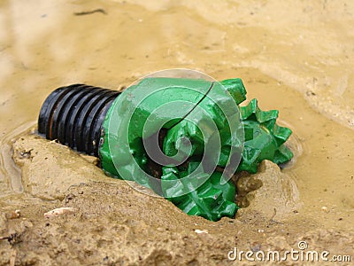 Oil drilling bit in mud Stock Photo