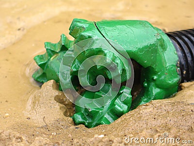 Oil drilling bit in mud Stock Photo