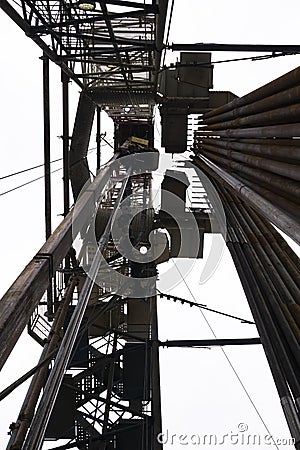 Oil drilling rig on the field. Oil field, Onshore drilling rig around with agriculture field. View from the another site of sugar Stock Photo