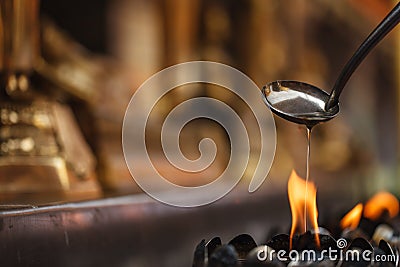 Oil filling in Thai style metal candle Stock Photo