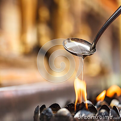 Oil filling in Thai style metal candle Stock Photo