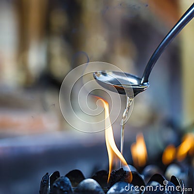 Oil filling in Thai style metal candle Stock Photo