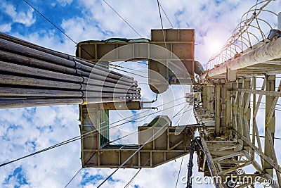 Oil and Gas Drilling Rig onshore dessert with dramatic cloudscape. Oil drilling rig operation on the oil platform Stock Photo