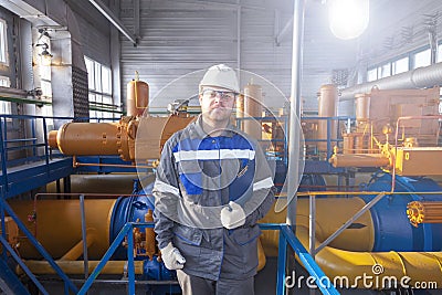 Oil, gas industry. The mechanic - the repairman, gas production operator opens the valve, gas equipment and fitting, toned Stock Photo