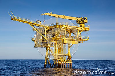 Oil and gas wellhead remote platform produced raw gas and oil then sent to central processing platform Stock Photo