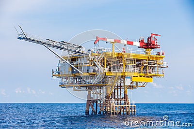 Oil and gas wellhead remote platform produced raw gases and crude then sent to central processing platform. Stock Photo