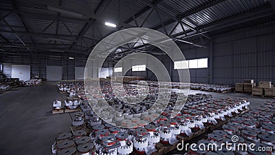 Oil and Gas Wellhead tree equipment production plant. Light turns on in the warehouse. Parts of wellhead fittings and Stock Photo
