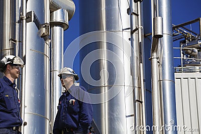 Oil and gas workers with large gas pipelines Stock Photo