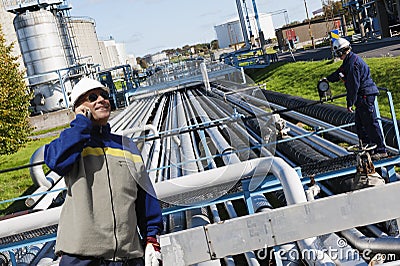 Oil and gas workers with pipelines Stock Photo