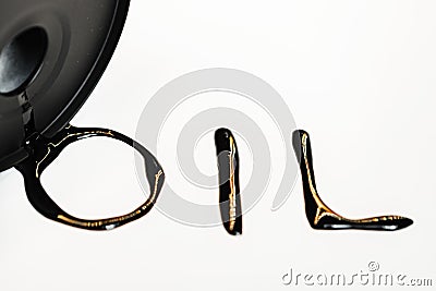 Oil industry concept. Spilled oil from a mini barrel on white background Stock Photo