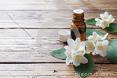 Oil of jasmine. Aromatherapy with jasmine oil. Jasmine flowers. Wooden background with copy space Stock Photo