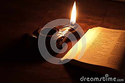 Oil lamp and Bible Stock Photo