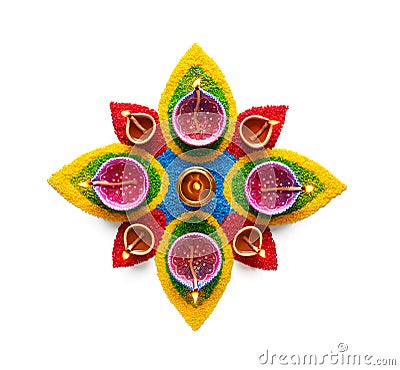 Oil lamp on colorful rangoli over white background Stock Photo