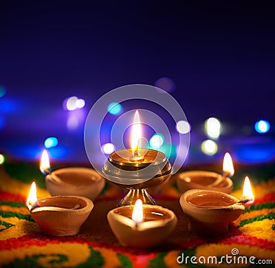 Oil lamps lit on colorful rangoli with copy space Stock Photo