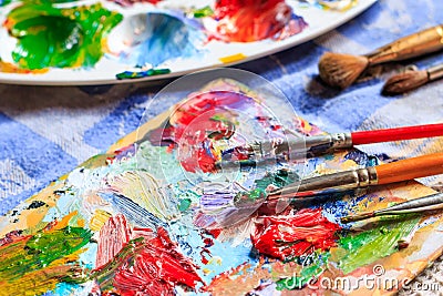 Oil paint, different types of brushes and palette Stock Photo